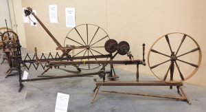 Kim's display. Three moving-spindle wheels from Falls Mill Museum.