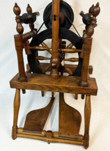 Close-up of front of spinning wheel marked B. SANFORD